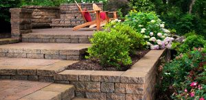 Paver steps with garden accent and wooden chairs