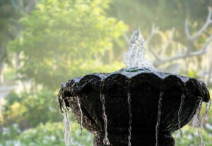 Fountain for garden decoration on blurred background. 